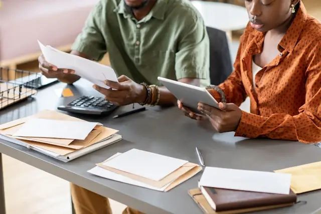 Couple Reviewing Financials at table.