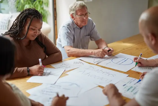 Group of residents planning, sitting at a table.